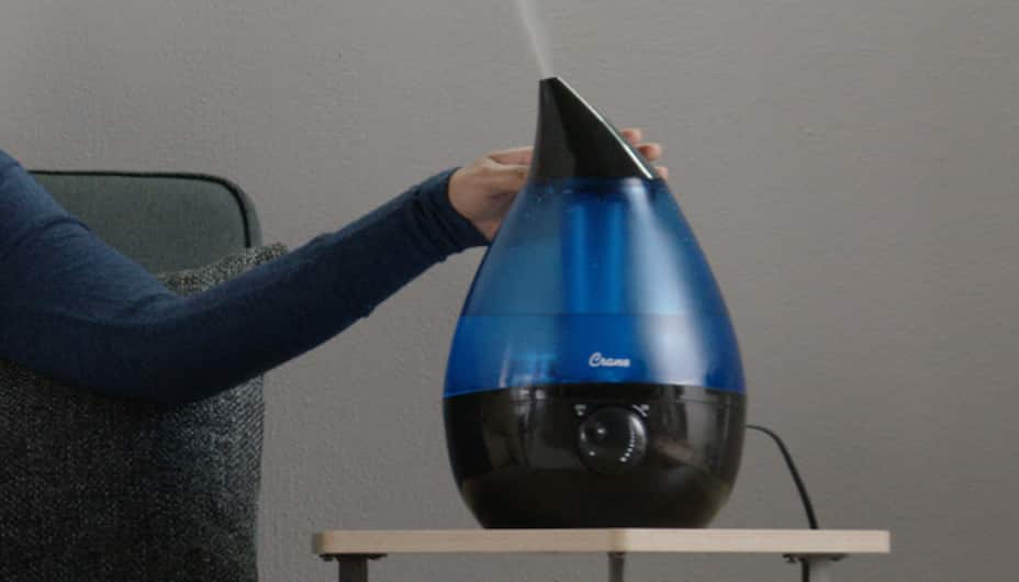 A person activates a humidifier.