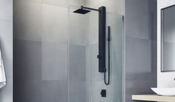 Une colonne de douche à 3 jets de massage haute pression VIGO Orchid, installée dans une douche carrelée de couleur grise.