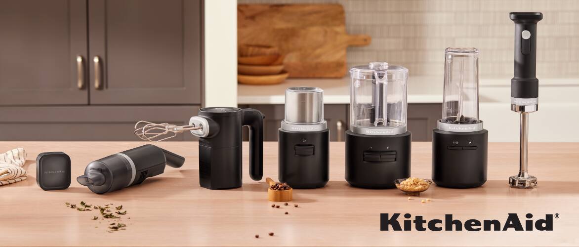 An assortment of KitchenAid Go™ cordless appliances on a kitchen countertop. 