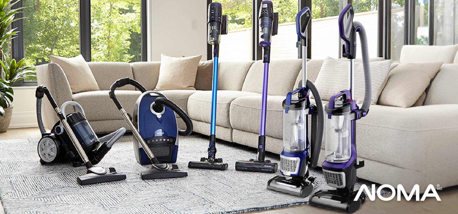 Assortment of NOMA vacuums in living room. 