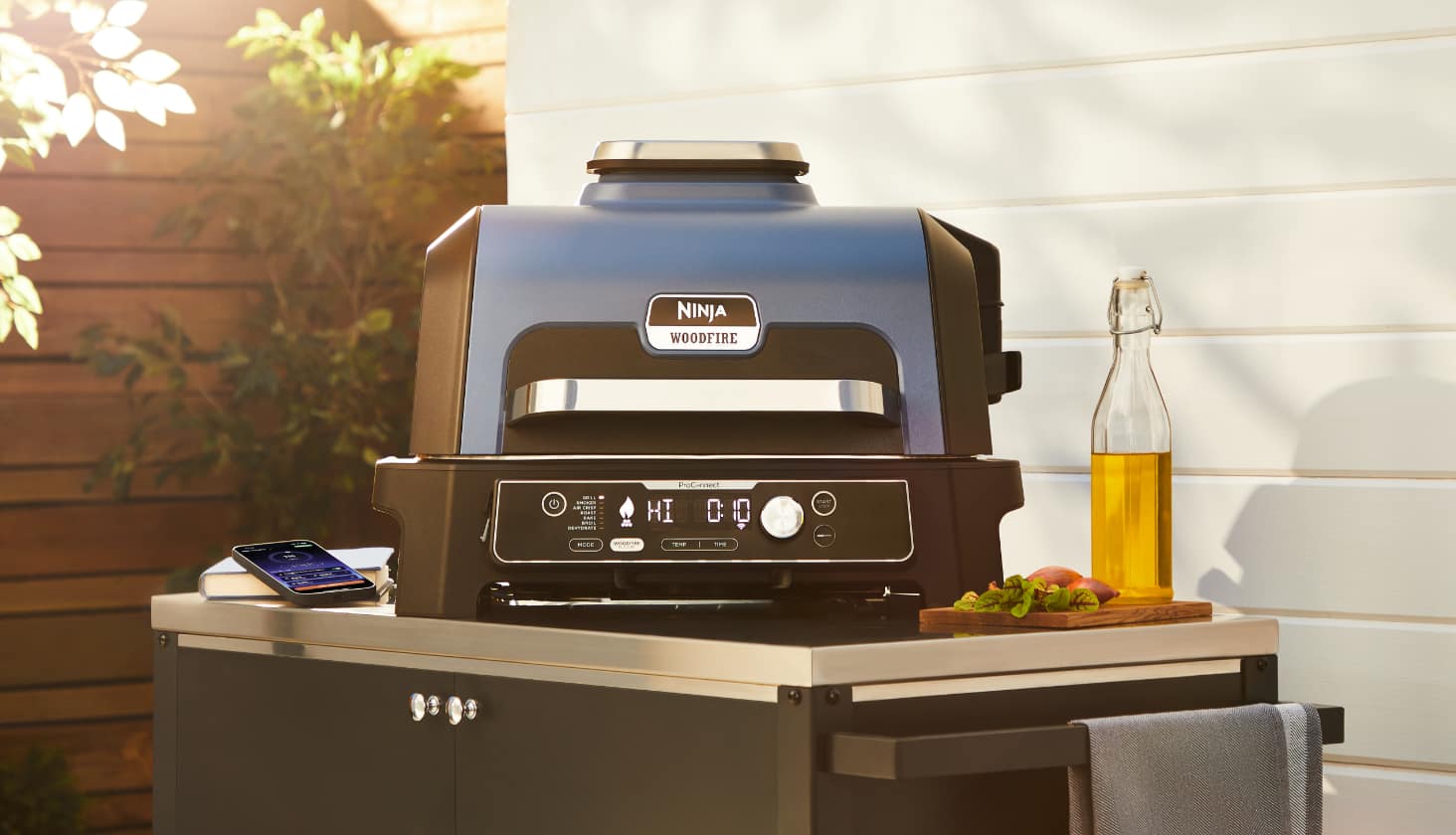 A Ninja Woodfire Pro Connect Grill & Smoker on a patio.