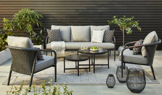 CANVAS Jasper Conversation Collection sofa, armchairs and 2-piece tables on a patio.