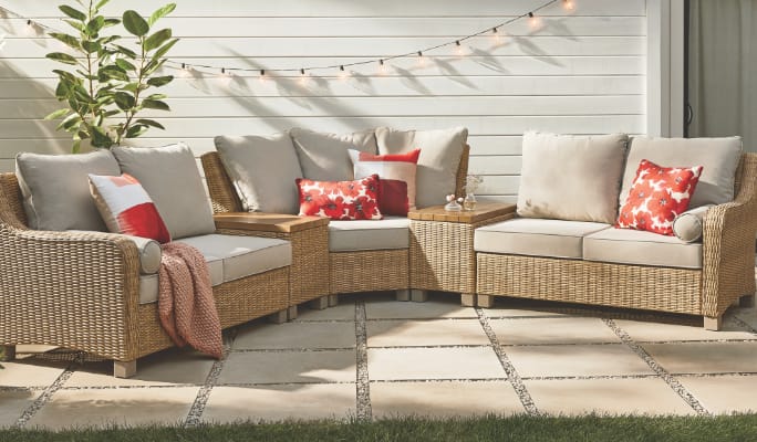 CANVAS Moraine Sectional set in a backyard with decorative cushions.