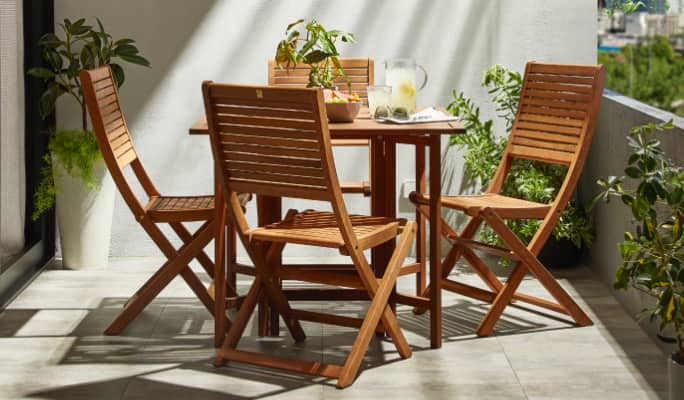A 5-piece wooden CANVAS Sherbrooke dining set on a balcony.