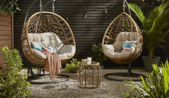 CANVAS Sydney Egg swing chairs with side table on patio.