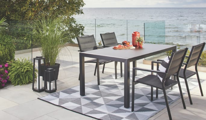 CANVAS Mercier dining set on a waterfront patio.