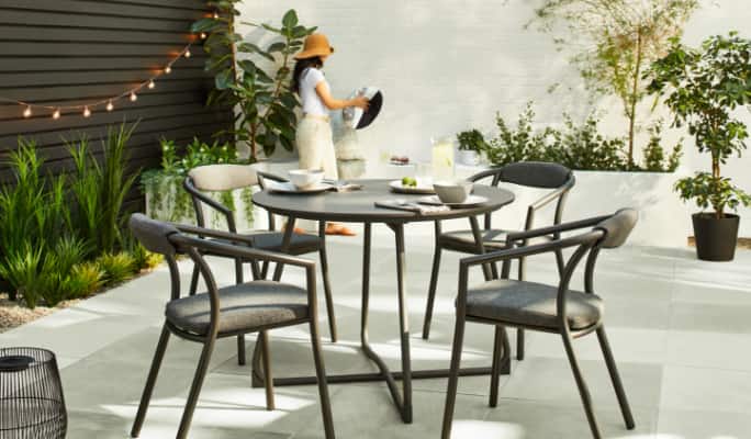 CANVAS Trent 5-Piece Dining Set with drinks and dishes on a patio.
