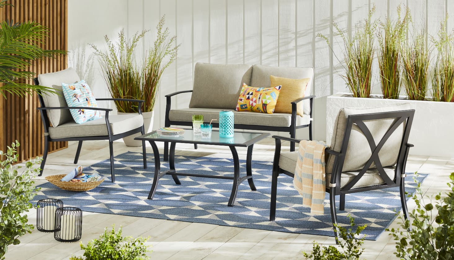 For Living Avenue Conversation Set including a loveseat, armchairs and a coffee table on a patio.
