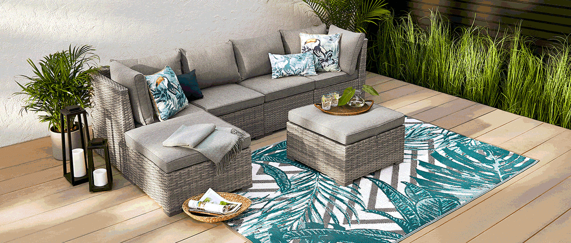 CANVAS Bala 6-piece Sectional Set on a  patio with potted plants and an ottoman.
