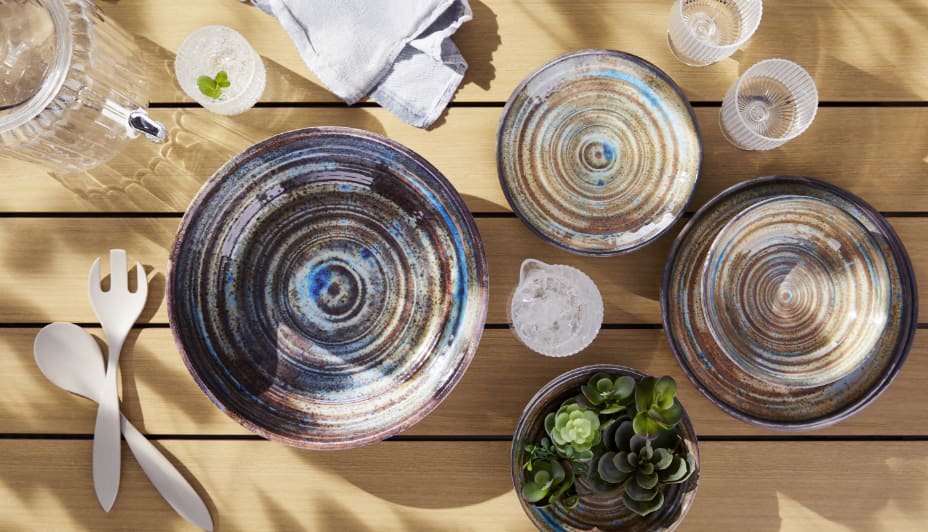  CANVAS Seashore Outdoor Serving Bowls and utensils on a patio table. 