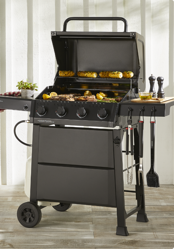 MASTER Chef Discover 4-Burner Propane BBQ grilling steaks and veggies outside.