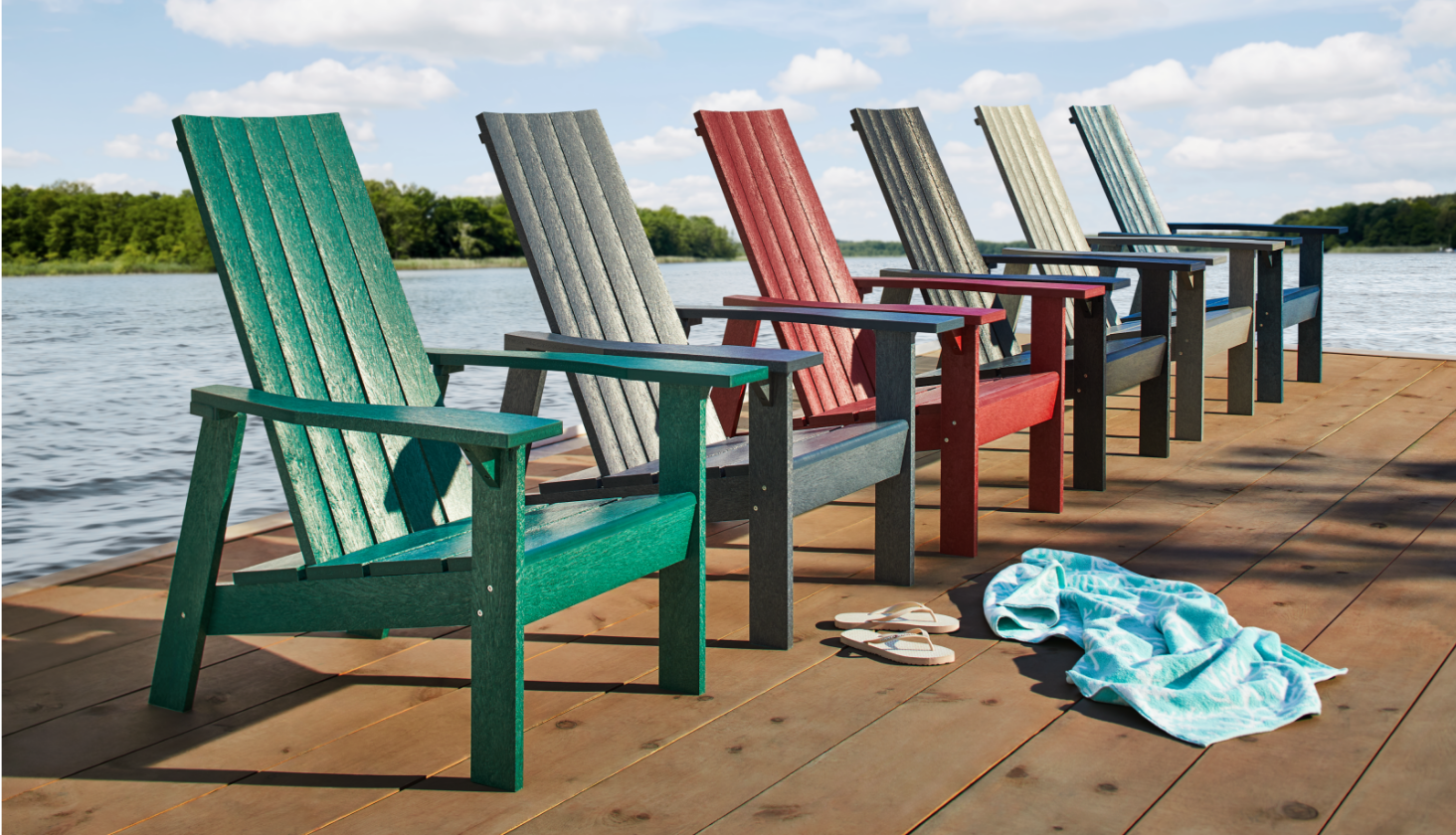 A row of six assorted CANVAS Arrowhead Muskoka chairs on a dock. 