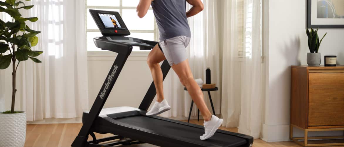 An adult running on a NordicTrack EXP 5i Treadmill, 23.