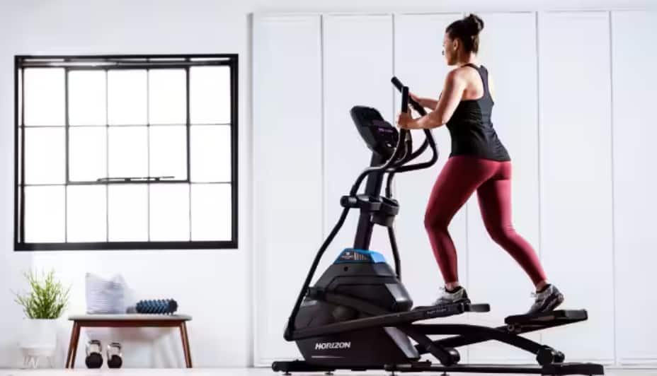 Person using an elliptical in their home  