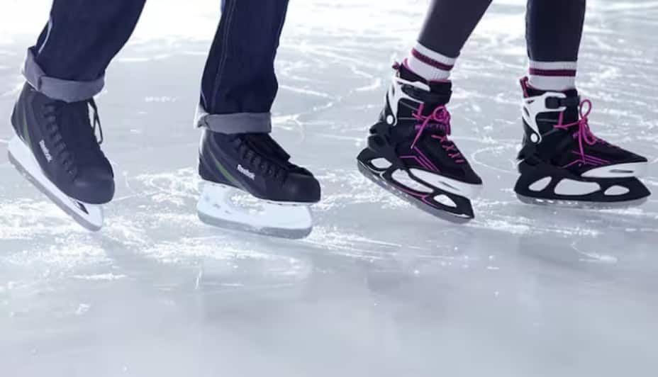 Two people ice skating  