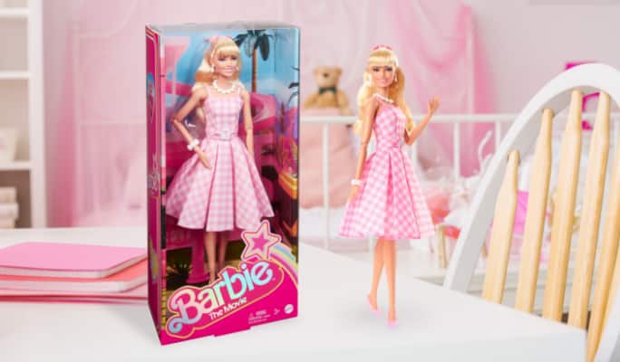 Barbie toys on display in pink room.