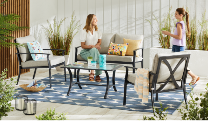 A woman and a child on a patio featuring the For Living Avenue Patio Conversation Set. 