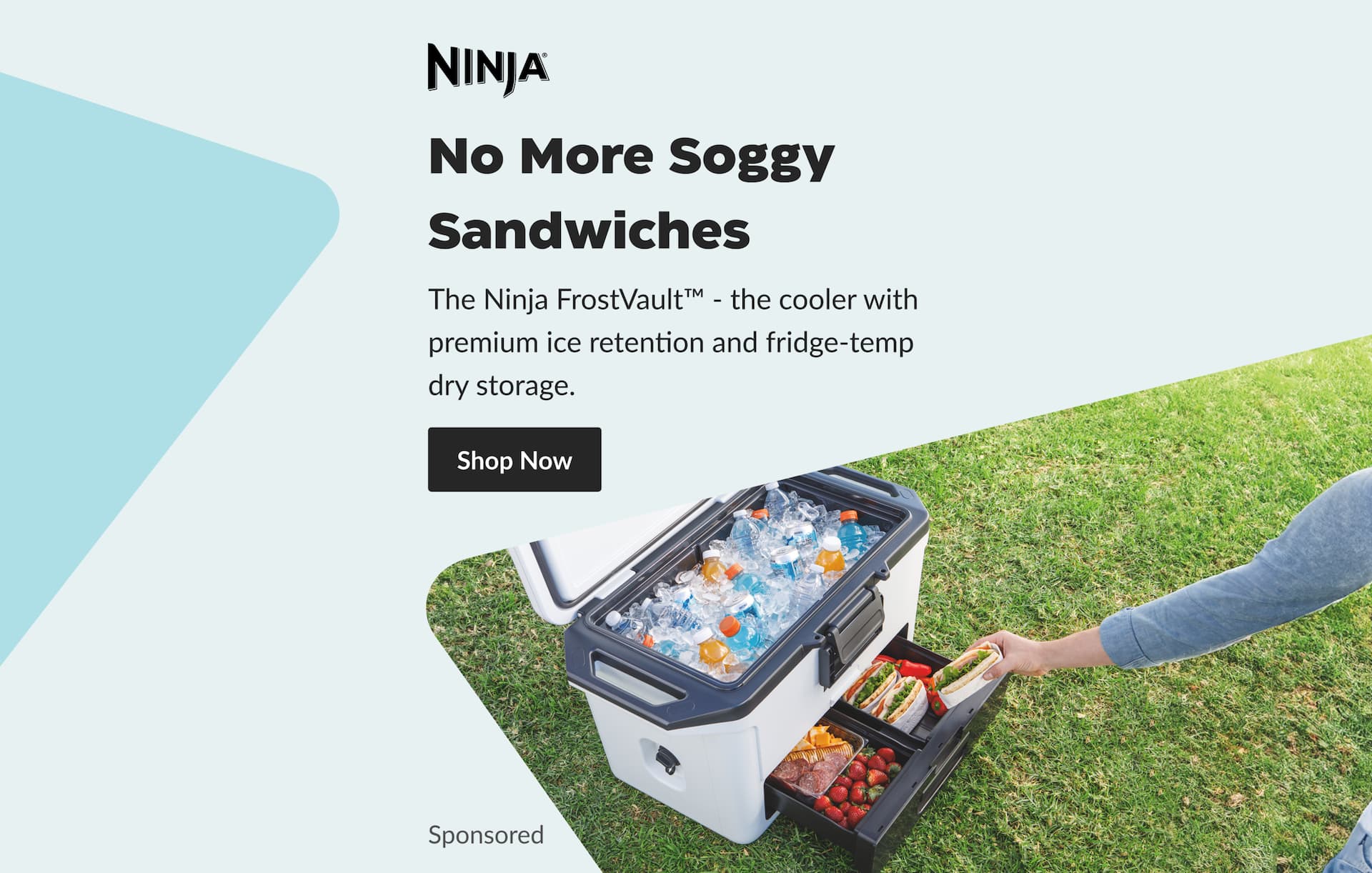 An adult grabbing a sandwich from the Dry Zone drawer of a Ninja FrostVault cooler.