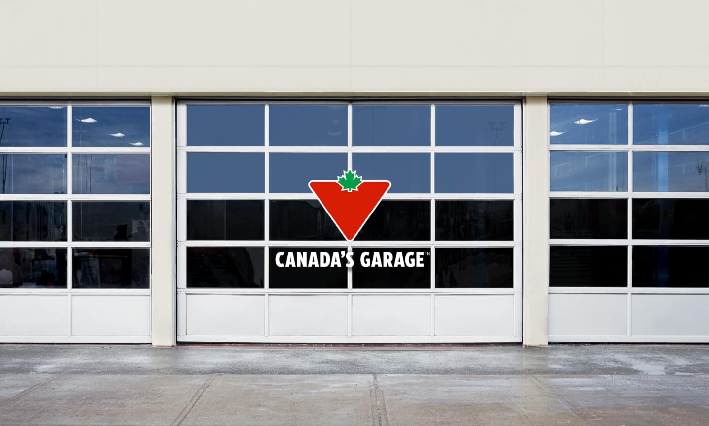 The “Canada’s Garage” logo in front of a row of service-bay doors.