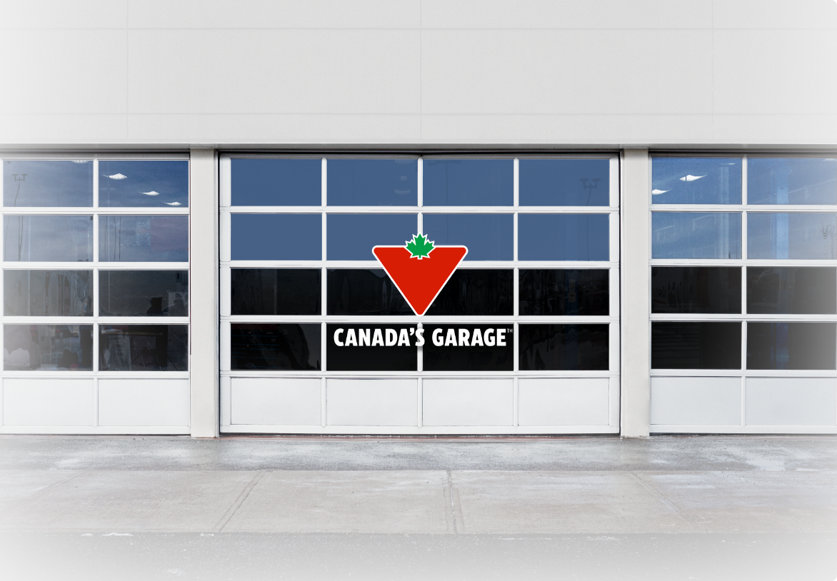 A set of service bay doors with the bearing the “Canada’s Garage” logo.