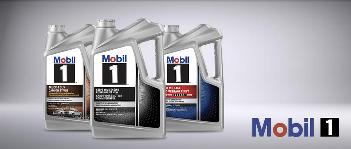 A row of three 4.73-L jugs of Mobil 1 motor oil.