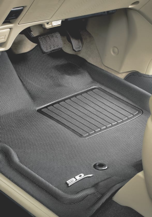 A grey 3D Maxpider floor liner lines the driver’s-side footwell of a car with a beige interior.