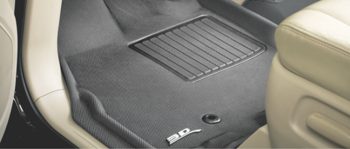 A grey 3D Maxpider floor liner lines the driver’s-side footwell of a car with a beige interior.