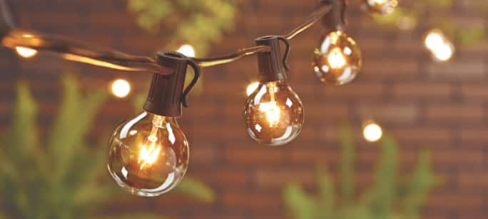 String lights hanging in a backyard.