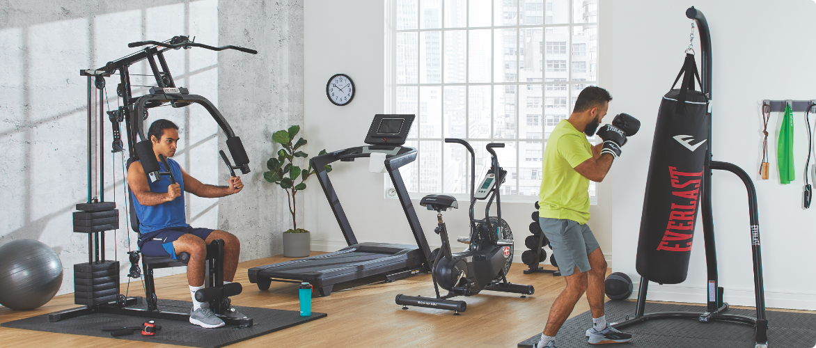 Man sitting on a workout bench lifting a barbell