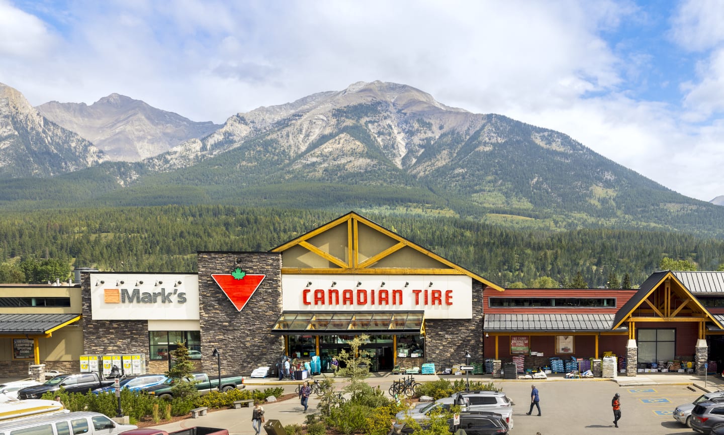 A Canadian Tire and Mark’s store side by side in a mountainous landscape in Canmore, Alberta.