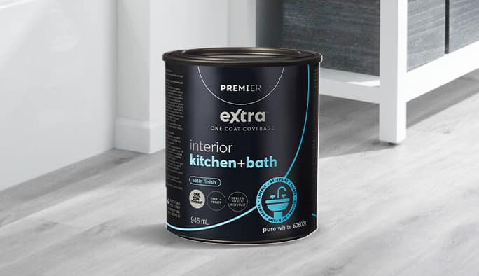 A can of Premier Interio Kitchen & Bath paint rests on a hardwood floor.