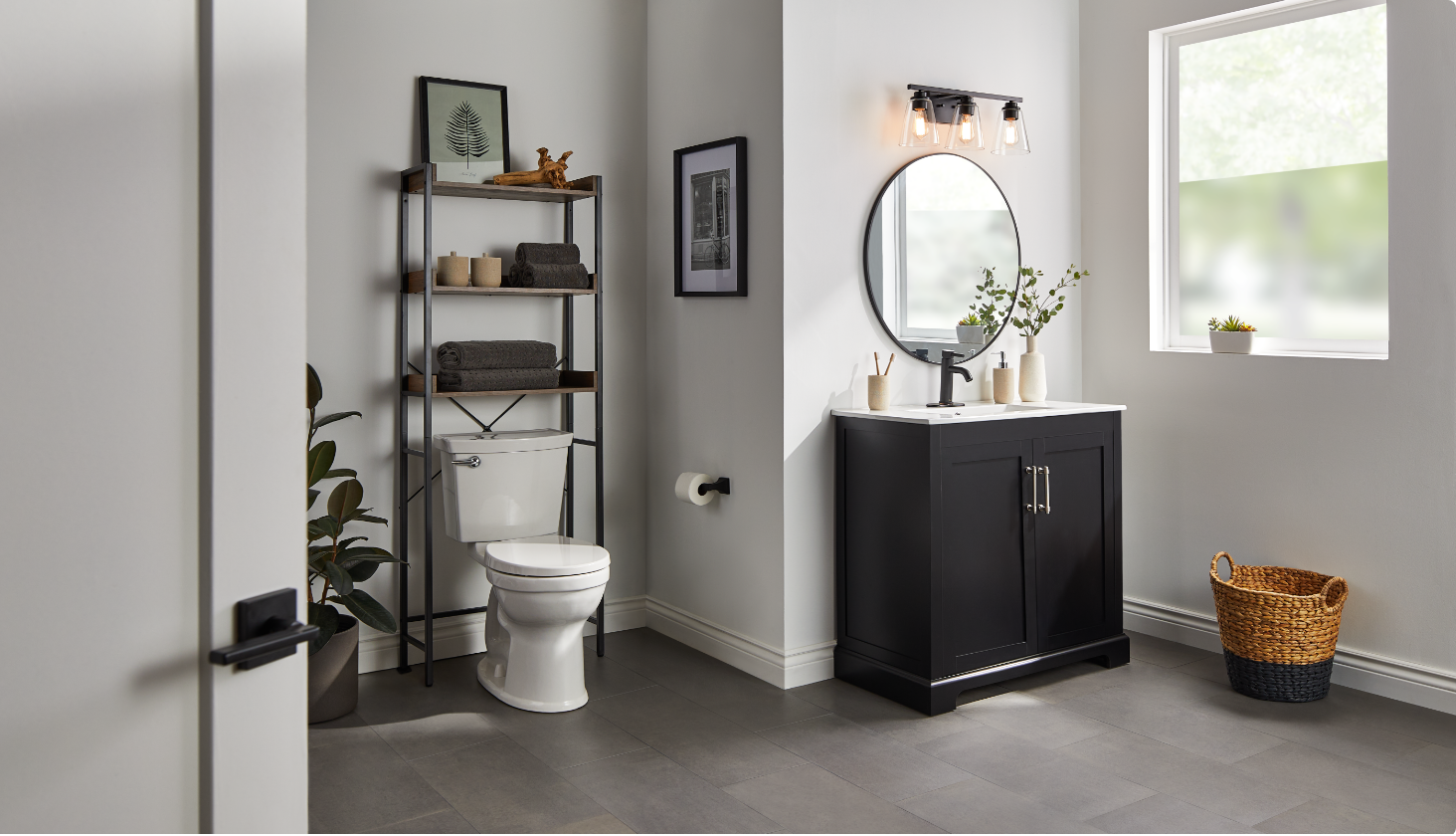 Grey and white bathroom with towel baskets, shower curtains, floor plant and decor