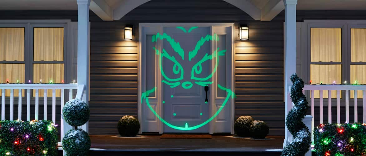 Grinch projection light show on house.