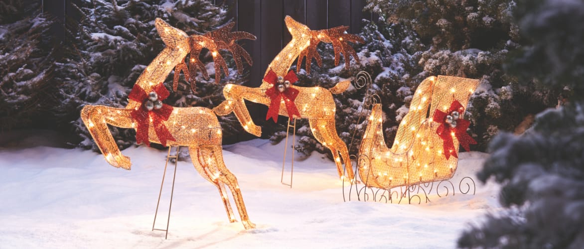 CANVAS LED 4-ft White Deer & Sleigh yard decoration on a front lawn of a house.