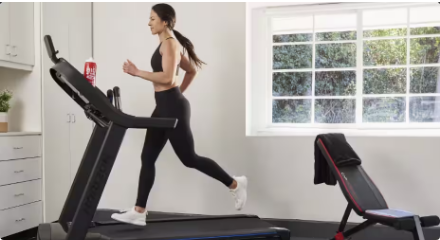 A woman running on a treadmill.