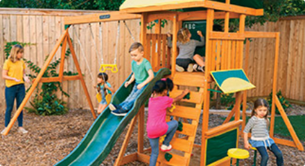 Four young children play on a KidKraft Brightside Wooden Play Centre.