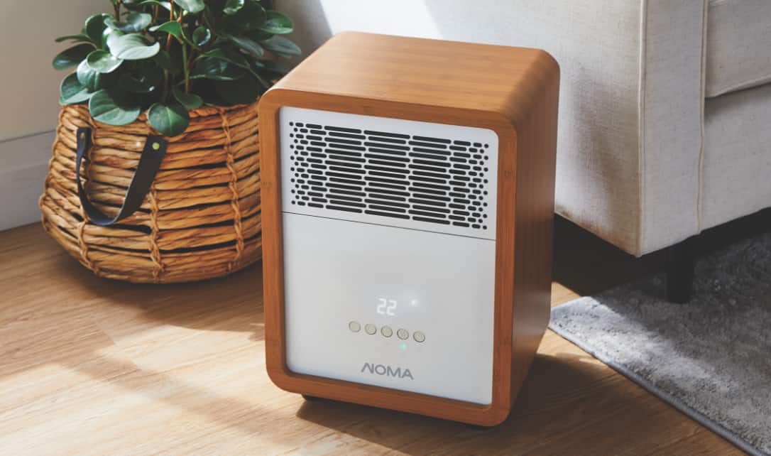 A Noma Cabinet Heater on the floor of a living room.