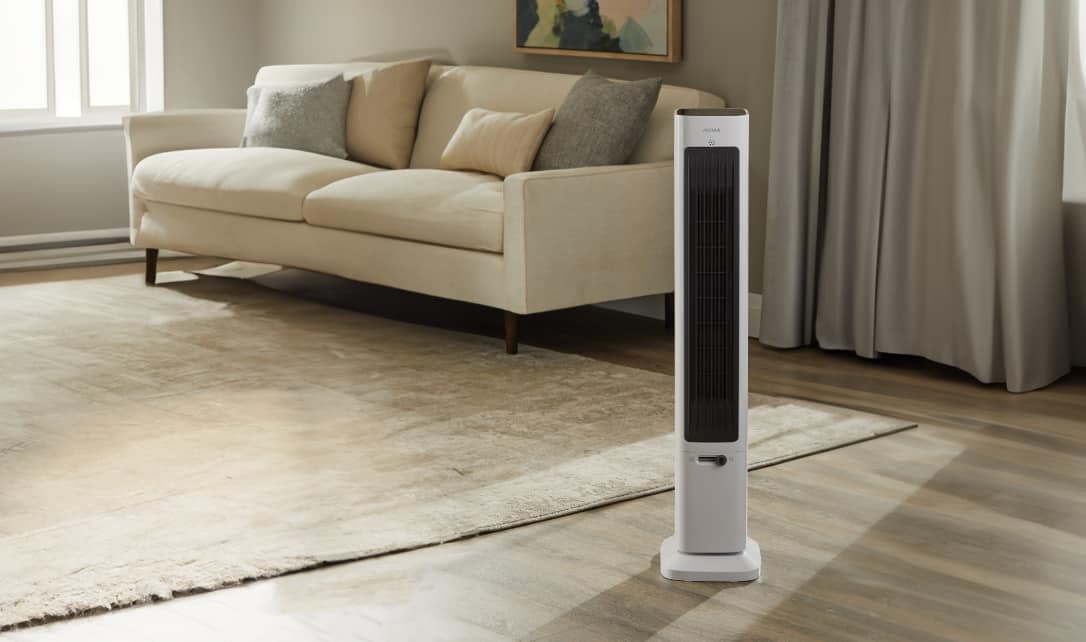 A Noma 2-in-1 Tower Fan & Heater in a living room. 