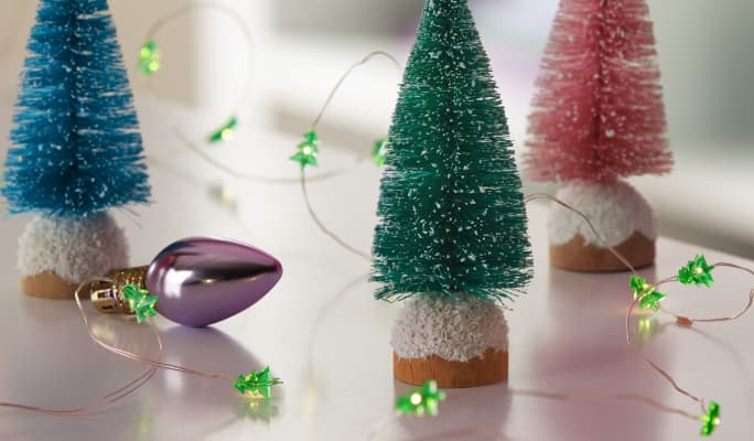 A string of CANVAS Battery operated mini tree string lights on a table.