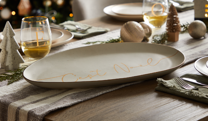 CANVAS C'est Noel Serving Platter on a dining table. 