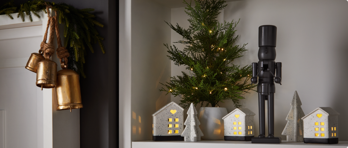 A shelf and mantle with assorted CANVAS Night Before Christmas decorations. 