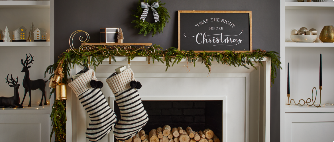 A mantle decorated with CANVAS Night Before Christmas decorations and stockings. 