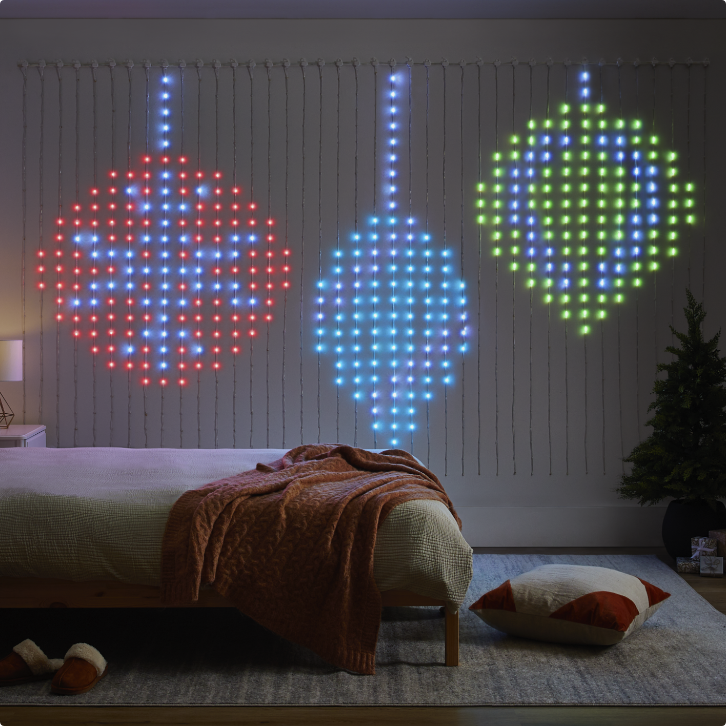 A NOMA 2 Smart light curtain display of ornament graphics hung on a wall in a bedroom.