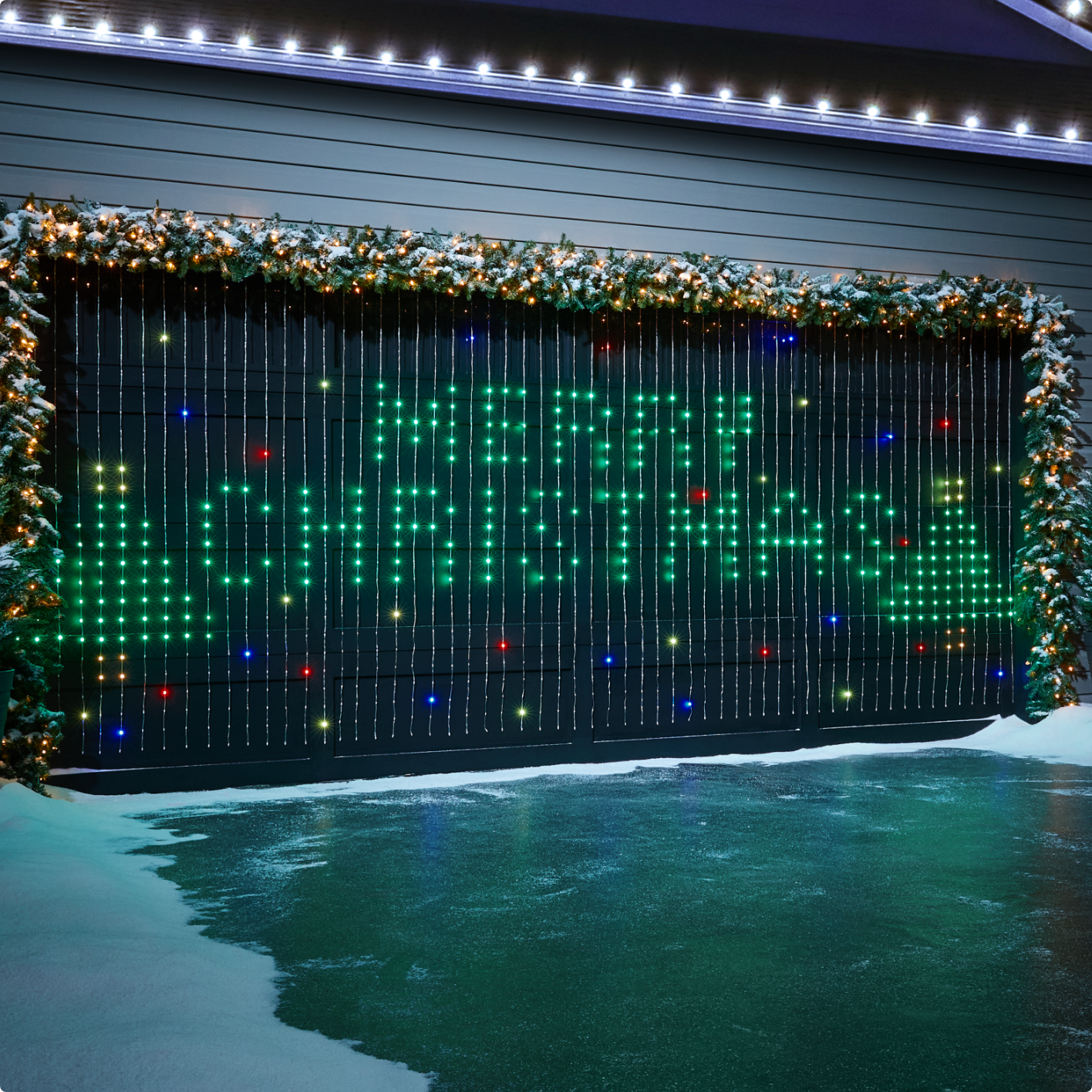 A large NOMA 3 Smart light curtain display that reads “Merry Christmas” hung on an exterior wall. 