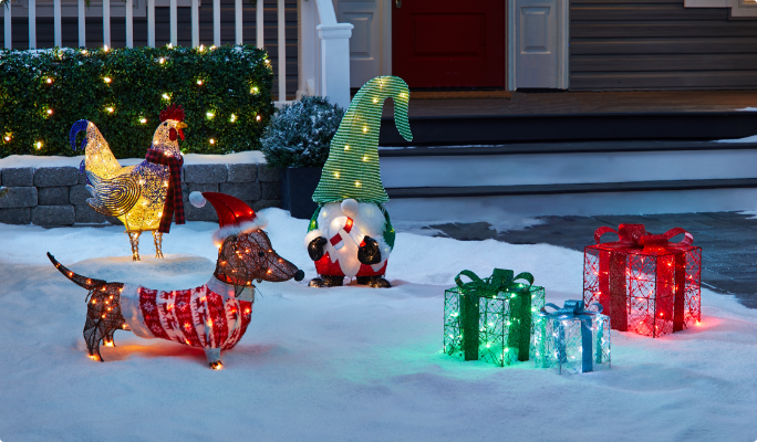 A range of CANVAS Whimsical pre-lit wireform figures on a snowy lawn