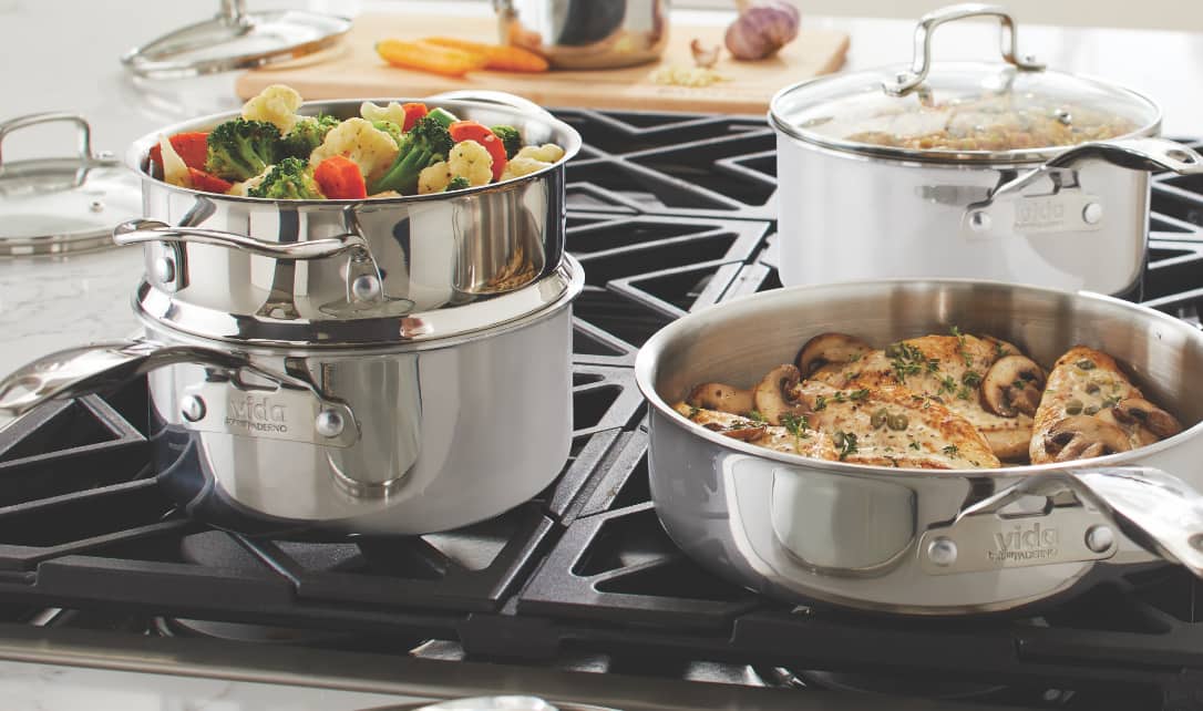 Food cooking on a stove in various Vida by PADERNO pans. 