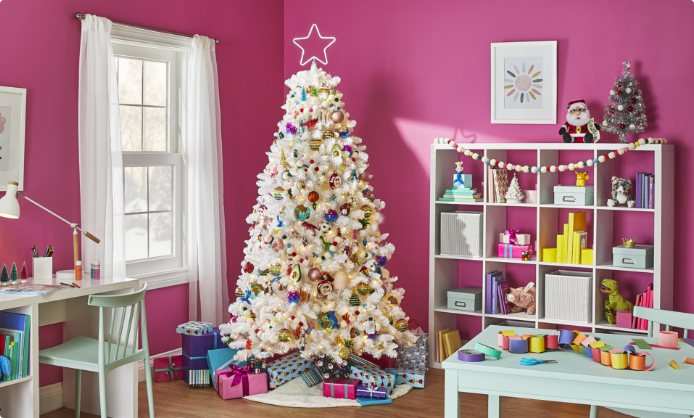 A pink room with a white Christmas tree and CANVAS Merry Mingle decorations.