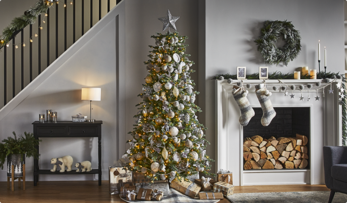 A living room with a Christmas tree and CANVAS Silver Frost decorations. 