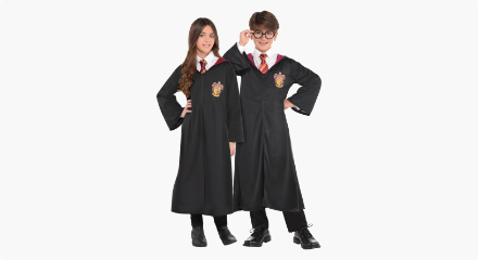 Two kids wearing Harry Potter Gryffindor Robes. 