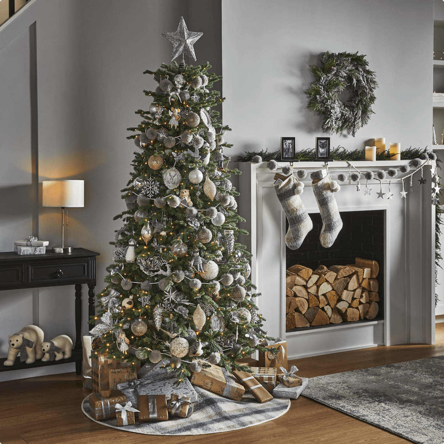 A Christmas Tree and fireplace mantle with CANVAS Silver Frost decorations. 